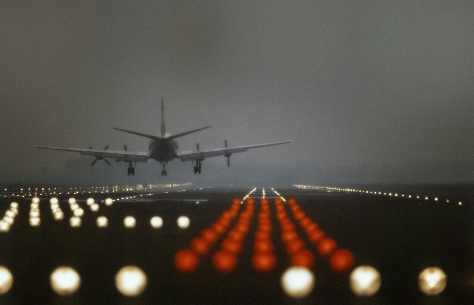 An aircraft landing on a runway at dusk